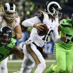Rams quarterback Jared Goff attempts to escape a pass rush by Seahawks defensive lineman Michael Bennett, left, and Seahawks linebacker Bobby Wagner at CenturyLink Field Thursday night in Seattle on December 15, 2016. (Kevin Clark / The Herald)