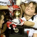 Archbishop Murphy quarterback Connor Johnson (right) and teammates admire the trophy after beating Liberty 56-14 in the Class 2A state championship game Saturday afternoon at the Tacoma Dome. (Kevin Clark / The Herald)