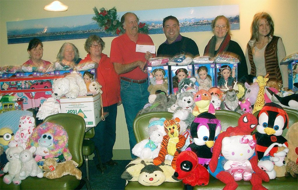 Everett Elks Lodge 479 members donated ten folding tables&rsquo; worth of toys as well as a check for $850 for Christmas House. Most of the monetary donation was raised from a Barnyard Bingo fundraiser. (Contributed photo)