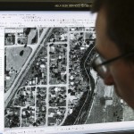 Joe Godfrey works on a computer-mapping project of a section of the Pilchuck River near Snohomish.                                (Ian Terry / The Herald)