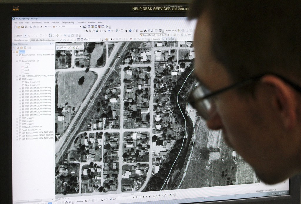 Joe Godfrey works on a computer-mapping project of a section of the Pilchuck River near Snohomish.                                (Ian Terry / The Herald)