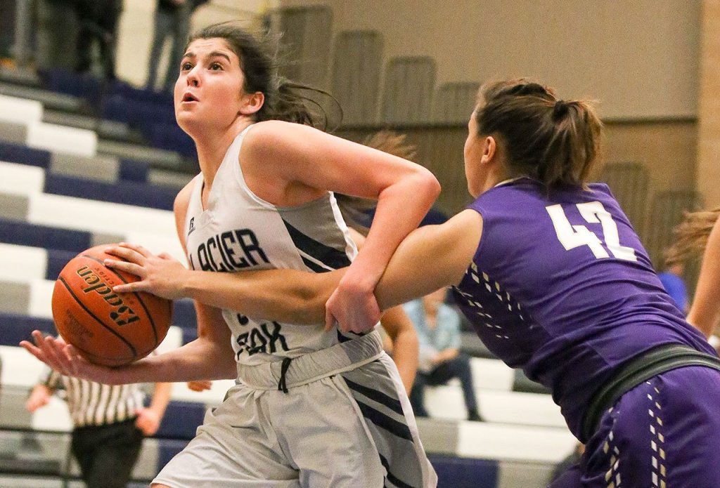 Lake Stevens&rsquo; Rocky Leenstra (right) reaches in to knock the ball loose from Glacier Peak&rsquo;s Samantha Fatkin on Wednesday night at Glacier Peak High School in Snohomish. (Kevin Clark / The Herald)