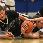 Jackson&rsquo;s Jordan Brajcich (left) and Glacier Peak&rsquo;s Bo Burns struggle for a loose ball during a game Friday at Glacier Peak High School in Snohomish. The Grizzles defeated the Timberwolves 64-41. (Kevin Clark / The Herald)
