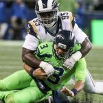 Seahawks quarterback Russell Wilson is tackled by Rams defensive lineman William Hayes at CenturyLink Field Thursday night in Seattle on December 15, 2016. (Kevin Clark / The Herald)