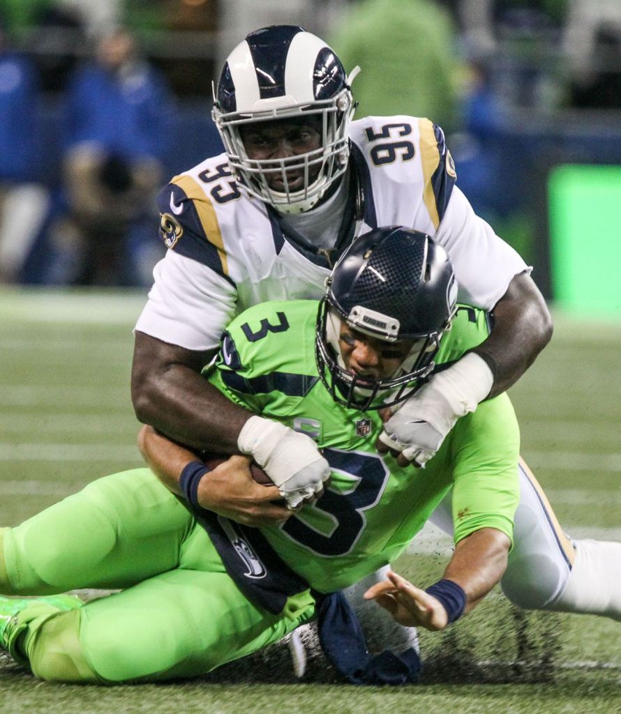 Seahawks quarterback Russell Wilson is tackled by Rams defensive lineman William Hayes at CenturyLink Field Thursday night in Seattle on December 15, 2016. (Kevin Clark / The Herald)