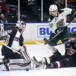 The Giants&rsquo; Ryan Kubic stops a shot with the Silvertips&rsquo; Eetu Tuulola and the Giants&rsquo; Bailey Dhaliwal looking on in the first period Wednesday night at Xfinity Arena in Everett. (Kevin Clark / The Herald)