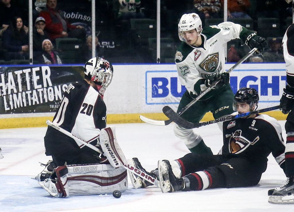 The Giants&rsquo; Ryan Kubic stops a shot with the Silvertips&rsquo; Eetu Tuulola and the Giants&rsquo; Bailey Dhaliwal looking on in the first period Wednesday night at Xfinity Arena in Everett. (Kevin Clark / The Herald)