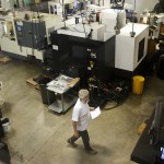 A worker walks along the shop floor of RB Enterprises in Mukilteo on Wednesday. (Ian Terry / The Herald)