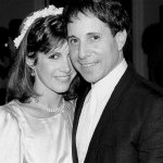 In this March 11, 1982 photo, actress Carrie Fisher and singer-composer Paul Simon leave the Cathedral of St. John the Divine in New York, after a memorial service for comedian John Belushi. (AP Photo/Marty Lederhandler, File)