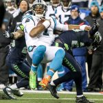 Panthers quarterback Cam Newton is tackled by Seahawks corner back Jeremy Lane Sunday night at CenturyLink Field in Seattle on December 4, 2016.(Kevin Clark / The Herald)