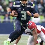 Seahawks quarterback Russell Wilson strambles for yargage against Saturday afternoon at CenturyLink Field in Seattle on December 24, 2016. The Cardinals won 34-31. (Kevin Clark / The Herald)