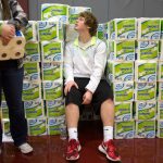 Sam Barnes peers over wall of toilet paper rolls as he and Katrina Bishop wait to hand them out to students, alumni and volunteers gathering and delivering food and other items from Cascade High School on Wednesday, Dec. 14, 2016 in Everett, Wa. (Andy Bronson / The Herald)