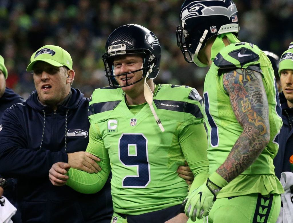 Seahawks punter Jon Ryan is helped off the field after a 50 yard run at CenturyLink Field Thursday night in Seattle on December 15, 2016. (Kevin Clark / The Herald)
