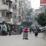 In this Dec. 5 a Syrian girl pushes a cart loaded with cooking gas canisters, in Aleppo, Syria. (AP Photo/Hassan Ammar)