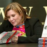 In this Feb. 20, 2004 photo, author Carrie Fisher autographs her new book &ldquo;The Best Awful&rdquo; at a promotional event in London. (AP Photo/John D. McHugh, File)