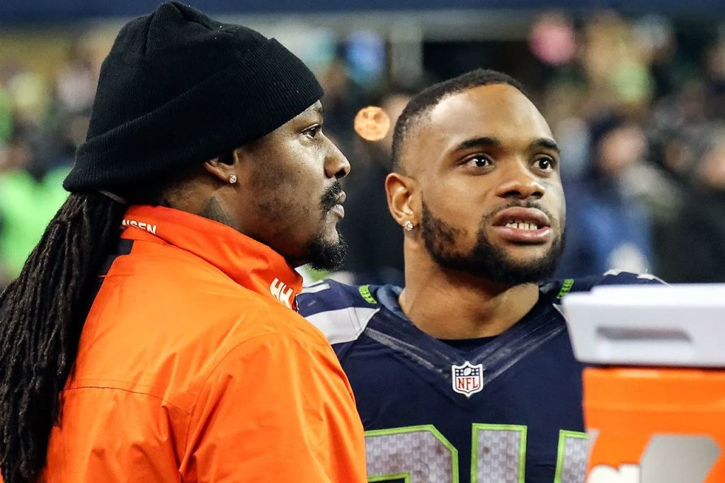 Former Seahawks running back Marshawn Lynch, left, talks with current Seahawks running back Thomas Rawls during the game against the Panthers Sunday night at CenturyLink Field in Seattle on December 4, 2016.(Kevin Clark / The Herald)