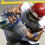 Archbishop Murphy&rsquo;s Anfernee Gurley stiff-arms Liberty&rsquo;s Dulin Hayden during the 2A state championship game on Saturday at the Tacoma Dome. Archbishop Murphy defeated Liberty 56-14. (Kevin Clark / The Herald)