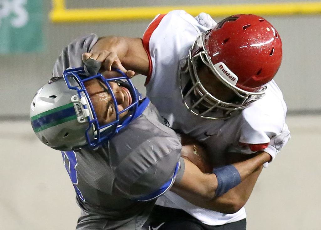 Archbishop Murphy&rsquo;s Anfernee Gurley stiff-arms Liberty&rsquo;s Dulin Hayden during the 2A state championship game on Saturday at the Tacoma Dome. Archbishop Murphy defeated Liberty 56-14. (Kevin Clark / The Herald)