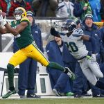 Green Bay wide receiver Davante Adams catches a touchdown pass in front of Seattle cornerback Jeremy Lane in the first half of Sunday&rsquo;s game. (AP Photo/Mike Roemer)