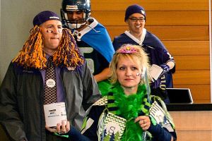 Snohomish County employees show off their favorite sports-fan regalia in October during a fundraising fashion show at the county administration building. Last week, they donated $1,209 to the Everett Gospel Mission Women and Children&rsquo;s Shelter. (Photo courtesy Snohomish County)