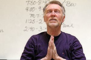 From a seat on an electric scooter, and with wife Diane Brooks nearby, Paul MacNaughton leads a yoga class at Everett Community College on April 25, 2013. MacNaughton died Dec. 16 following a long battle with bone cancer. (Dan Bates / The Herald)
