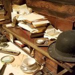 A desk is crowded with research and notes. (Christina Okeson / The Herald)