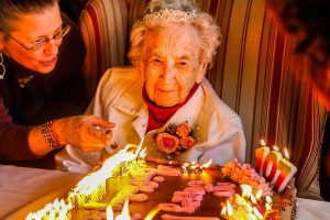 Brookdale Stanwood program coordinator Amy Fierke lets Dorothy Dillon know her birthday candles, all 107 of them, are ready to be blown out during her party Wednesday. (Dan Bates / The Herald)