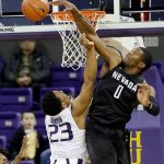 Nevada&rsquo;s Cameron Oliver (0) blocks a shot by Washington&rsquo;s Carlos Johnson in the first half of Sunday&rsquo;s game in Seattle. (AP Photo/Elaine Thompson)