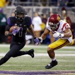 Washington&rsquo;s John Ross, left, runs with the ball as Southern California&rsquo;s Uchenna Nwosu chases him in the first half of a game Saturday, Nov. 12, in Seattle. (AP Photo/Elaine Thompson)