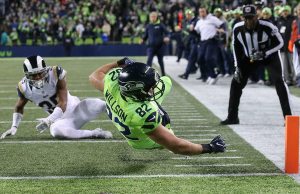 Seahawks tight end Luke Willson dives across the goal line for a touchdown with Rams Mike Jordan trailing at CenturyLink Field Thursday night in Seattle. (Kevin Clark / The Herald)