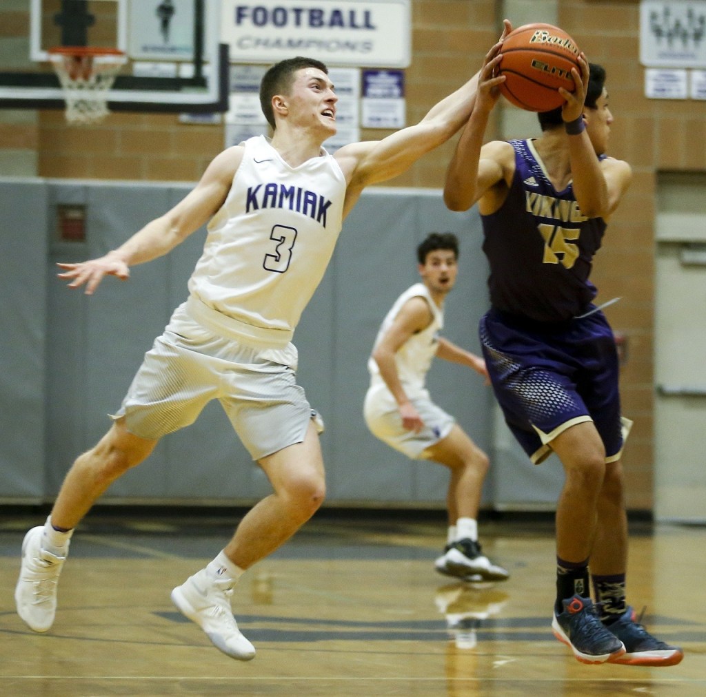 Kamiak&rsquo;s Carson Tuttle (left) attempts a steal on a pass intended for Lake Stevens&rsquo; Dominick McLaurin during a game at Kamiak High School in Mukilteo on Tuesday. (Ian Terry / The Herald)
