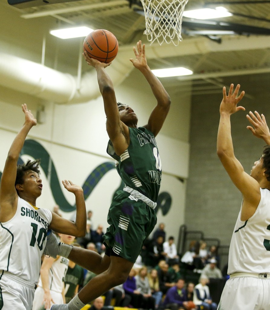 Edmonds-Woodway&rsquo;s Uchenna Acholonu (center) goes up for a shot during a game against Shorecrest at Shorecrest High School in Shoreline on Thursday. Shorecrest won 68-67. (Ian Terry / The Herald)