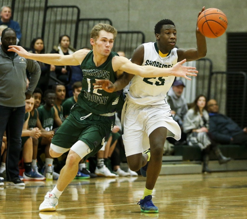 Edmonds-Woodway&rsquo;s Noah Becker (left) and Shorecrest&rsquo;s Omar Camara battle for a loose ball during a game at Shorecrest High School in Shoreline on Thursday. Shorecrest won 68-67. (Ian Terry / The Herald)