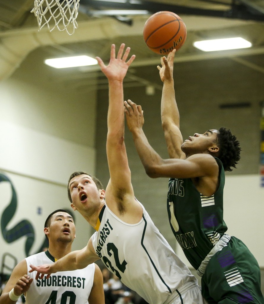 Edmonds-Woodway&rsquo;s Uchenna Acholonu (right) is fouled by Shorecrest&rsquo;s Simon Acker during a game at Shorecrest High School in Shoreline on Thursday. Shorecrest won 68-67. (Ian Terry / The Herald)
