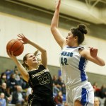 Lynnwood&rsquo;s Taylor Fahey (23) goes up for a shot as Shorewood&rsquo;s Taryn Shelley (42) defends during a game at Shorewood High School in Shoreline on Friday. (Ian Terry / The Herald)