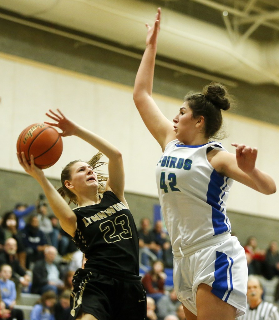 Lynnwood&rsquo;s Taylor Fahey (23) goes up for a shot as Shorewood&rsquo;s Taryn Shelley (42) defends during a game at Shorewood High School in Shoreline on Friday. (Ian Terry / The Herald)