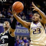 Washington guard Carlos Johnson grabs a rebound during a Dec. 18 game in Seattle. (AP Photo/Ted S. Warren)