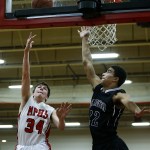 Marysville Pilchuck&rsquo;s Corbin Sims (34) takes a shot as Arlington&rsquo;s Dele Aribibola (22) defends during a game at Marysville Pilchuck High School on Wednesday. (Ian Terry / The Herald)