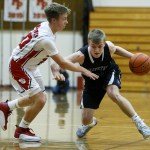 Arlington&rsquo;s Drew Bryson (right) drives to the hoop as Marysville Pilchuck&rsquo;s Luke Dobler defends during a game at Marysville Pilchuck High School on Wednesday. (Ian Terry / The Herald)