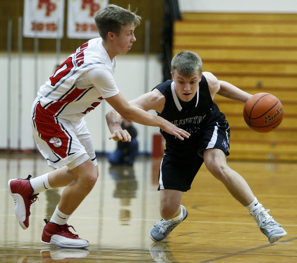 Arlington&rsquo;s Drew Bryson (right) drives to the hoop as Marysville Pilchuck&rsquo;s Luke Dobler defends during a game at Marysville Pilchuck High School on Wednesday. (Ian Terry / The Herald)