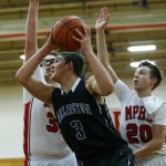 Arlington&rsquo;s Griffin Gardoski (center) goes up for a shot as he&rsquo;s guarded by a pair of Marysville Pilchuck defenders during a game at Marysville Pilchuck High School on Wednesday. (Ian Terry / The Herald)