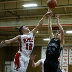 Marysville Pilchuck&rsquo;s Josiah Gould (left) swats away a shot attempt from Arlington&rsquo;s Anthony Whitis during a game at Marysville Pilchuck High School on Wednesday. (Ian Terry / The Herald)