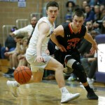 Kamiak&rsquo;s Carson Tuttle (left) steals the ball from Monroe&rsquo;s Justin Folz near the half court line as the final minutes tick away of a game at Kamiak High School on Friday. (Ian Terry / The Herald)