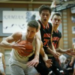 Kamiak&rsquo;s Keller Whitney (left) snatches an offensive rebound away from Monroe&rsquo;s Colby Kyle (center) and Justin Folz (right) during a game at Kamiak High School on Friday. (Ian Terry / The Herald)