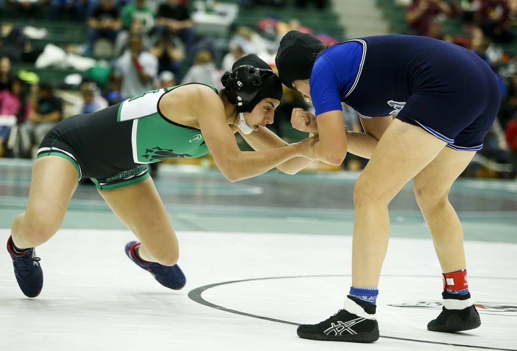 Brenda Reyna (left), a USA Wrestling Team member and Mount Vernon student, wrestles Federal Way&rsquo;s Edith Garcia during a bout at the Lady Wolfpack Invite In Mill Creek on Saturday. (Ian Terry / The Herald)