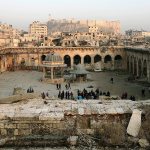 The Aleppo citadel, background, as people visit the heavily damaged inside of the Grand Umayyad mosque in the old city of Aleppo, Syria, on Thursday. (AP Photo/Hassan Ammar)