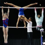 USA team members Ragan Smith (left) and Simone Biles (right) warm up prior to training Thursday, April 7, 2016, at Xfinity Arena in Everett. They were preparing for the Pacific Rim Gymnastics Championships. (Ian Terry / The Herald)