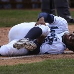 The AquaSox&rsquo;s Kyle Lewis grabs his right knee after colliding with Tri-City catcher in the AquaSox&rsquo;s lost to the Tri-City Dust Devils 8-6 at Everett Memorial Stadium on July 19, 2016, in Everett. Lewis, the Mariner&rsquo;s No. 1 draft pick, did not return to play during the game. ( Andy Bronson / The Herald )