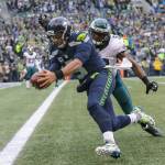 Seattle Seahawks quarterback Russell Wilson dives in for the touchdown as Philadelphia Eagles&rsquo; Nigel Bradham tries to hit the ball from his hands during the third quarter at CenturyLink Field on Nov. 20, 2016, in Seattle. (Andy Bronson / The Herald)