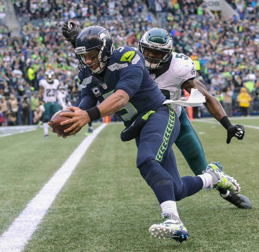 Seattle Seahawks quarterback Russell Wilson dives in for the touchdown as Philadelphia Eagles&rsquo; Nigel Bradham tries to hit the ball from his hands during the third quarter at CenturyLink Field on Nov. 20, 2016, in Seattle. (Andy Bronson / The Herald)